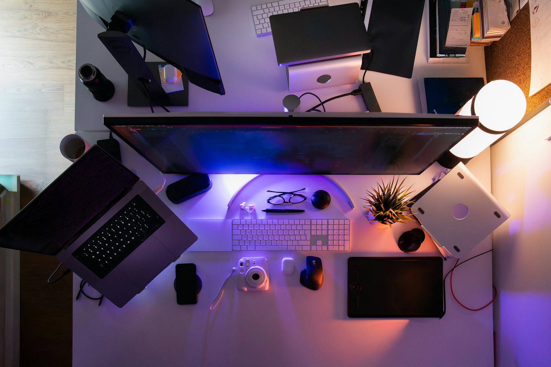 A computer desk with a lot of computers on top of it